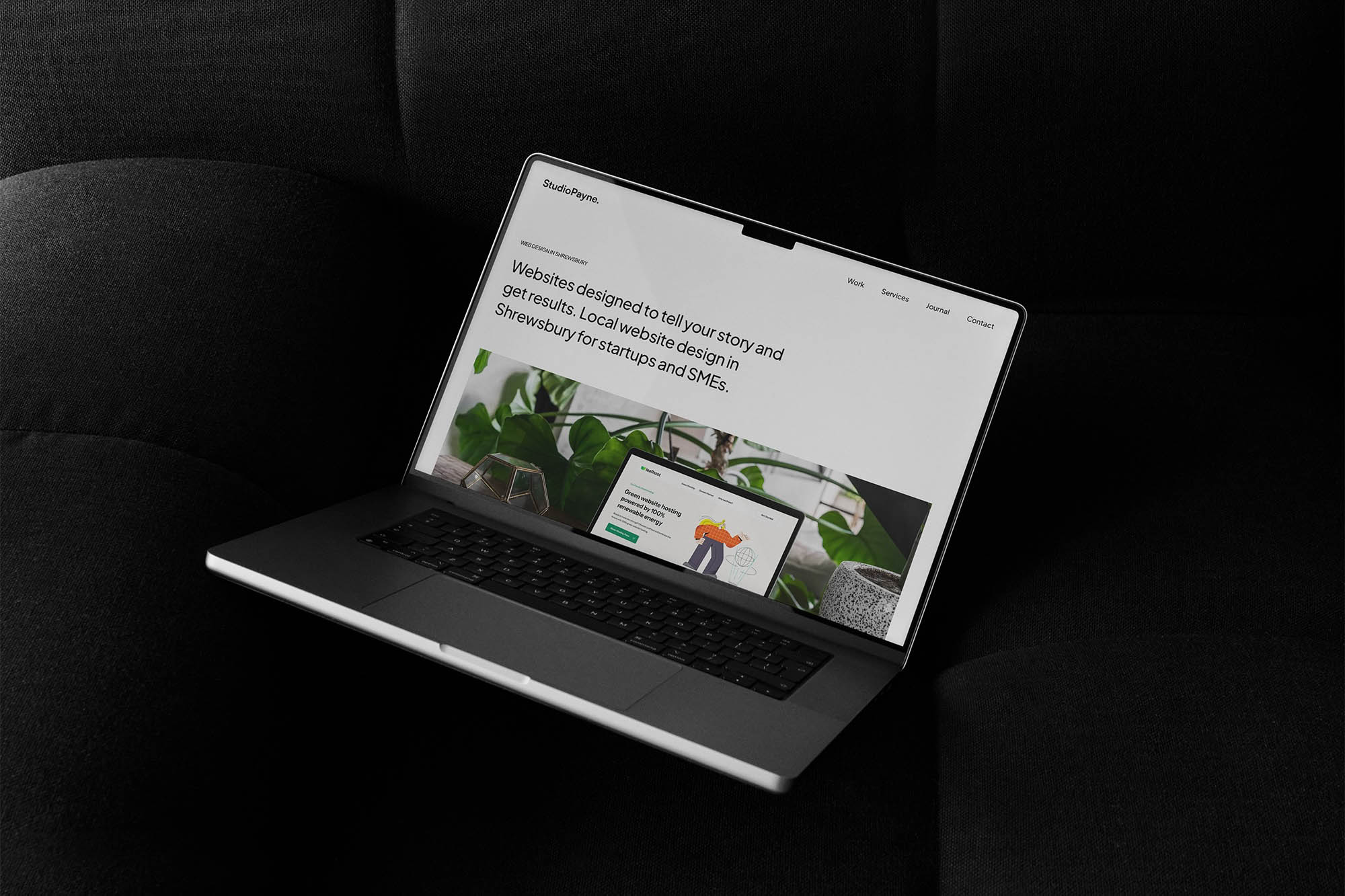 Website design services in Shrewsbury shown on MacBook with black fabric background.