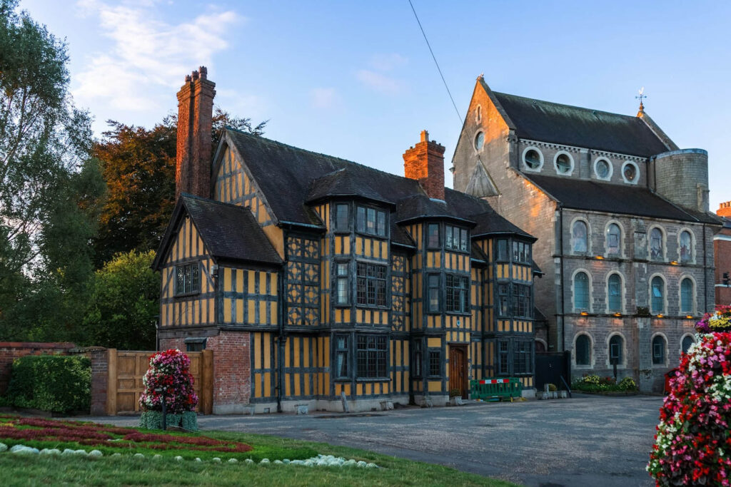 Historic tudor-style house with adjacent church building. Castle Gates House in Shrewsbury, Shropshire.