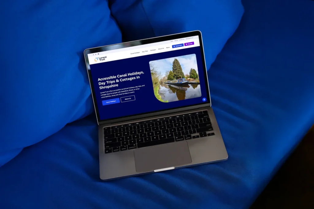 Accessible website design for Shropshire-based Lyneal Trust displayed on MacBook on blue sofa