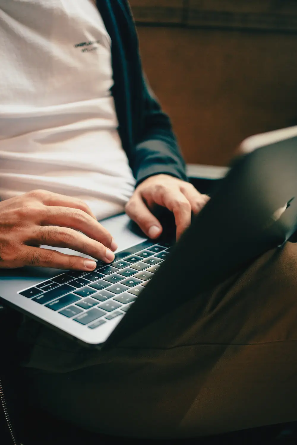 Graphic designer working on laptop, close-up of hands – web design and branding work